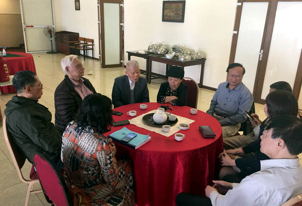 A group of people sitting around a tableDescription automatically generated