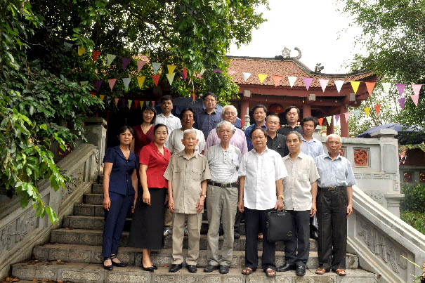 A group of people posing for a photo on a staircaseDescription automatically generated with medium confidence