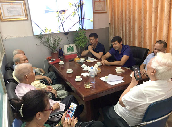 A group of people sitting around a tableDescription automatically generated