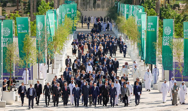 A group of people walking down a streetDescription automatically generated