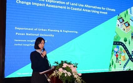 A person standing at a podium with a microphoneDescription automatically generated