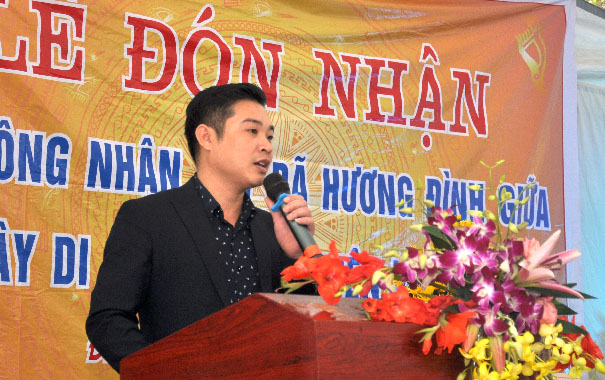 A person speaking into a microphoneDescription automatically generated