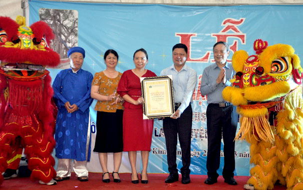 A group of people posing for a photo with a person in a garmentDescription automatically generated with medium confidence