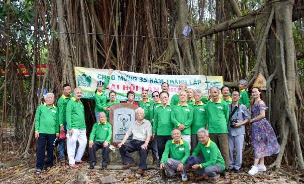 A group of people holding a bannerDescription automatically generated