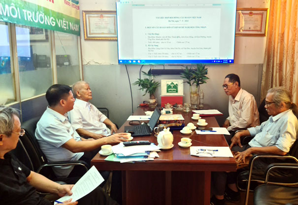 A group of men sitting around a tableDescription automatically generated