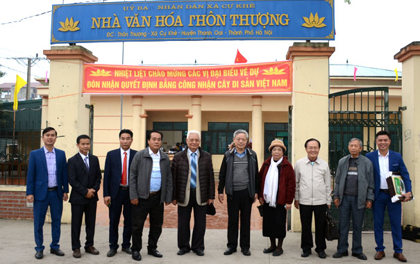 A group of people standing in front of a buildingDescription automatically generated