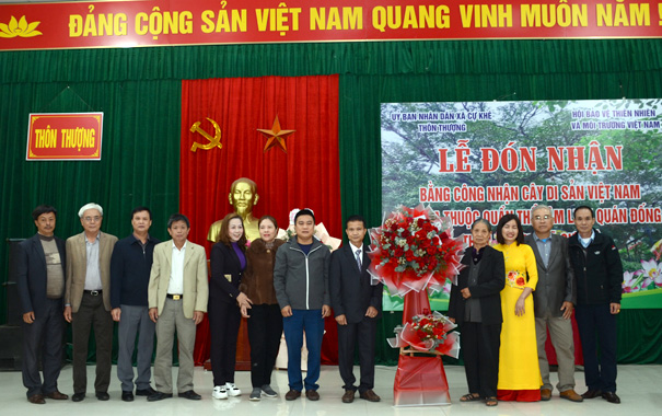 A group of people standing in front of a large statueDescription automatically generated