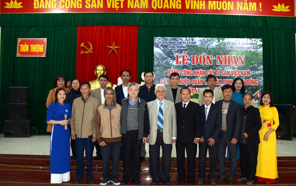 A group of people standing in front of a stageDescription automatically generated