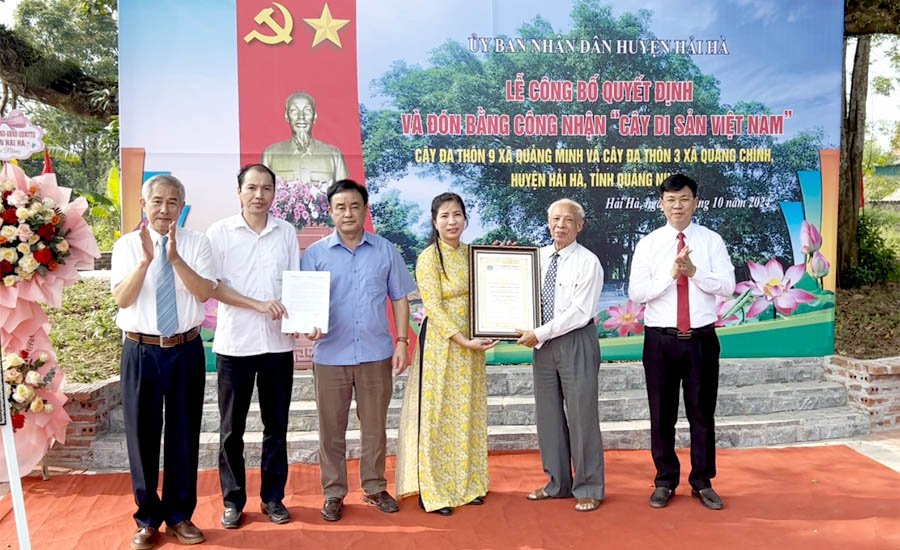 A group of people holding a certificateDescription automatically generated