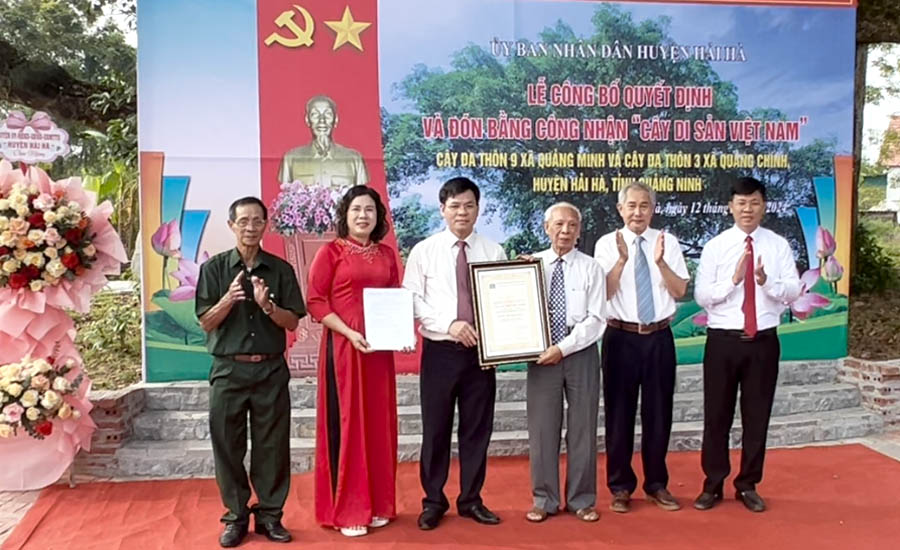 A group of people standing on a red carpetDescription automatically generated