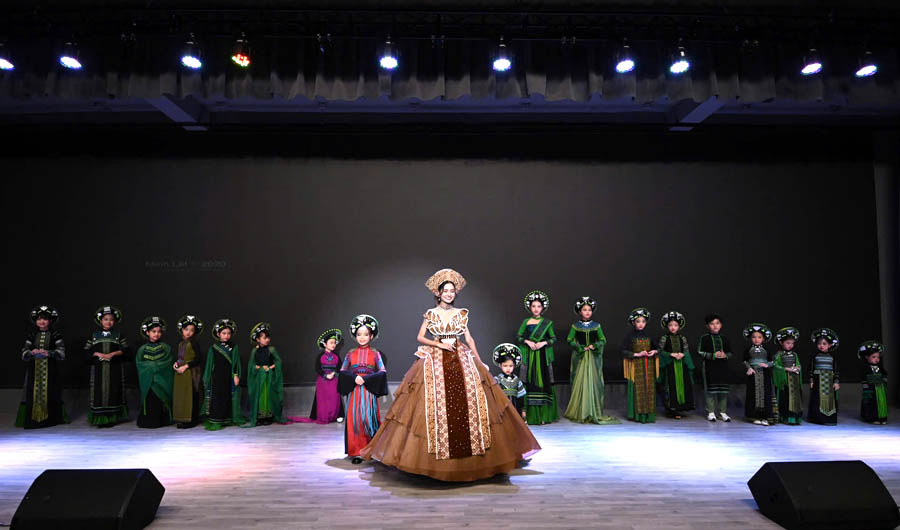 A group of women in clothing on stageDescription automatically generated