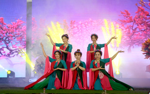A group of women performing on stageDescription automatically generated