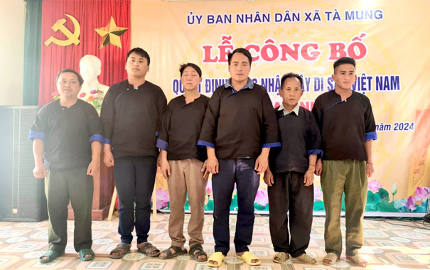 A group of men standing on a stageDescription automatically generated
