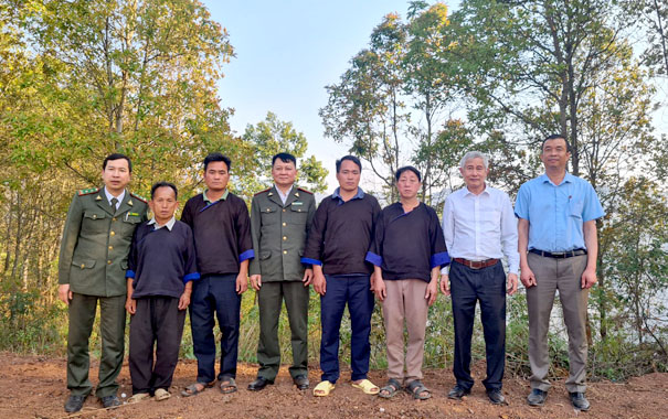 A group of men standing in a lineDescription automatically generated