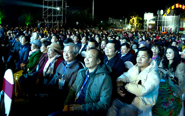 A group of people sitting in a crowdDescription automatically generated