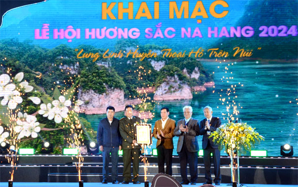 A group of men standing on a stageDescription automatically generated