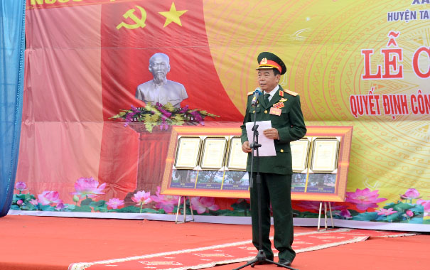 A person in a military uniform speaking into a microphoneDescription automatically generated