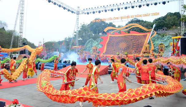 A group of people performing a dragon danceDescription automatically generated