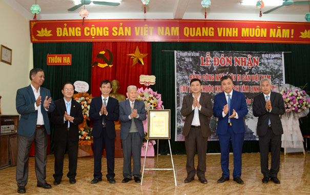 A group of men standing in front of a stageDescription automatically generated