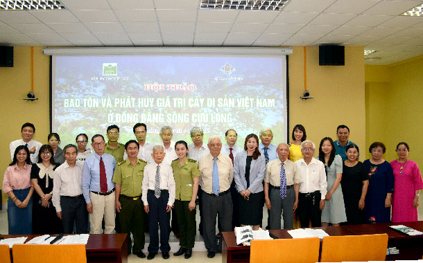 A group of people standing in front of a projector screenDescription automatically generated
