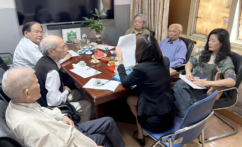 A group of people sitting around a tableDescription automatically generated
