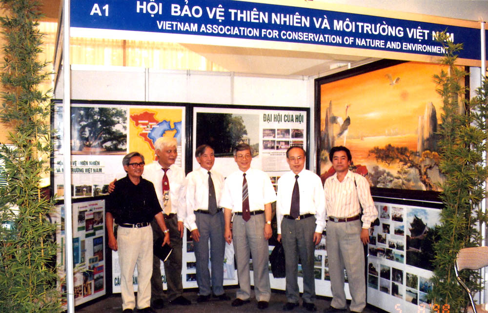 A group of men standing in front of a displayDescription automatically generated