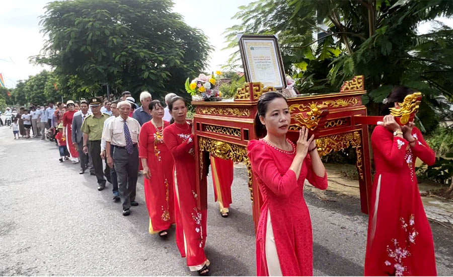 A group of people in red dresses carrying a coffinDescription automatically generated