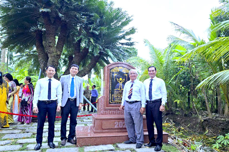 A group of men standing in front of a monumentDescription automatically generated
