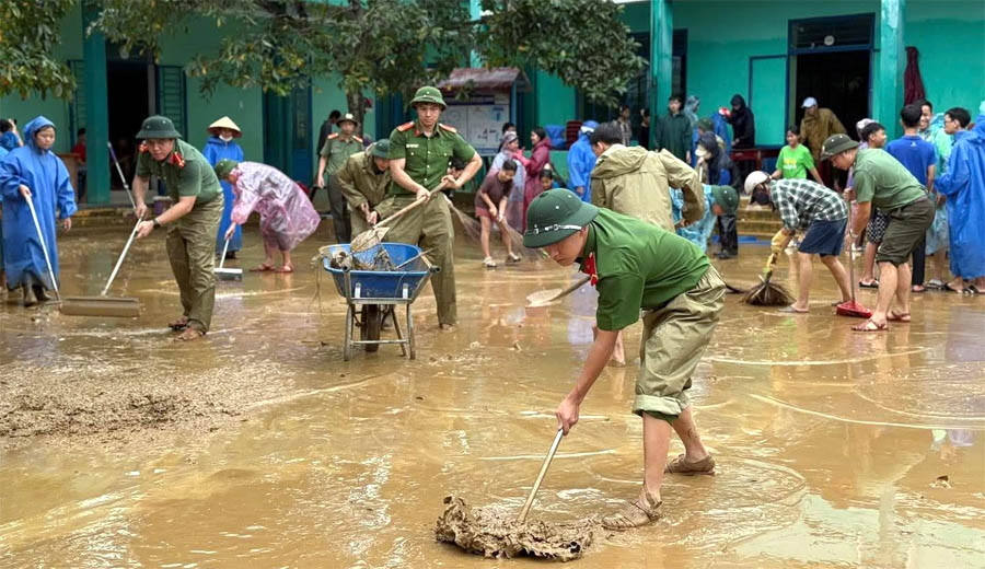 A group of people cleaning a muddy areaAI-generated content may be incorrect.