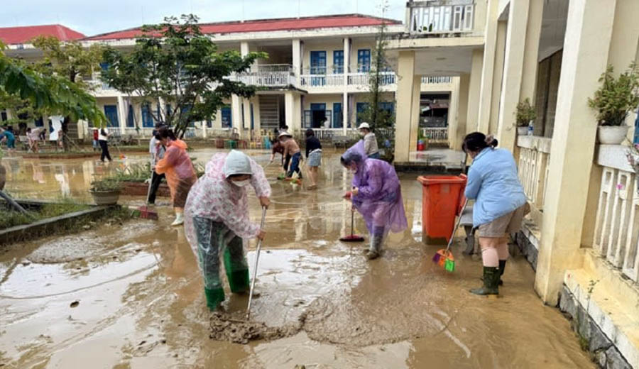 A group of people cleaning the groundAI-generated content may be incorrect.