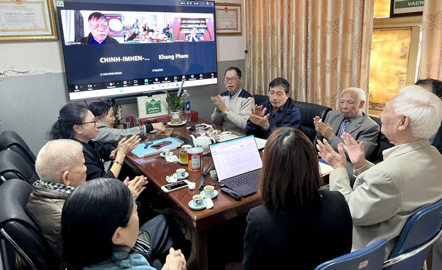 A group of people around a table clappingAI-generated content may be incorrect.