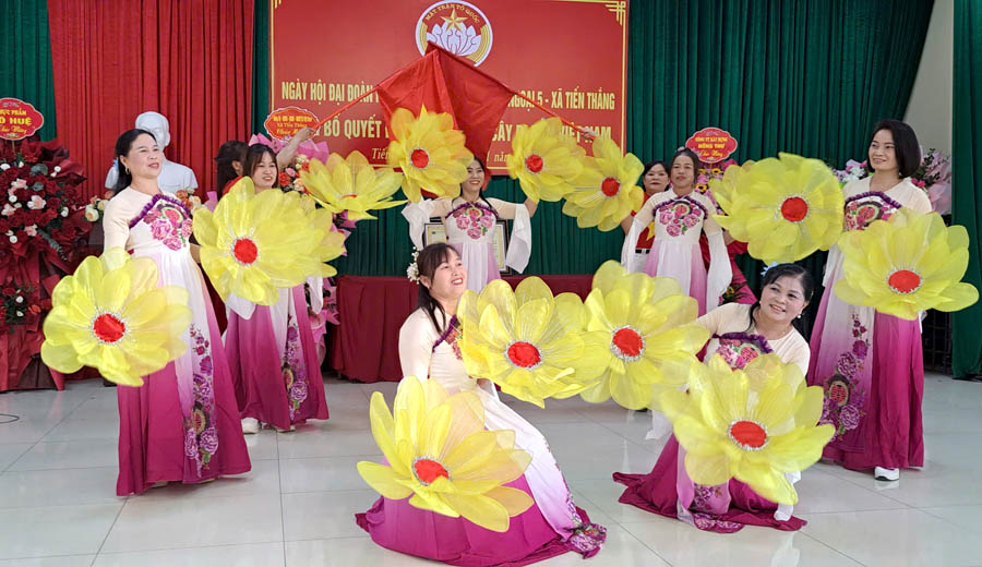 A group of women dancing with large yellow flowersAI-generated content may be incorrect.