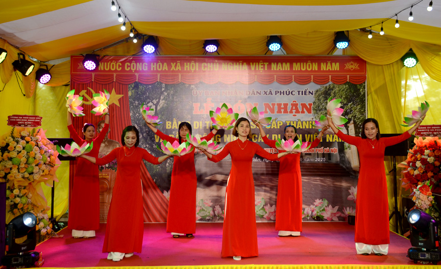 A group of women in red dresses on a stageAI-generated content may be incorrect.
