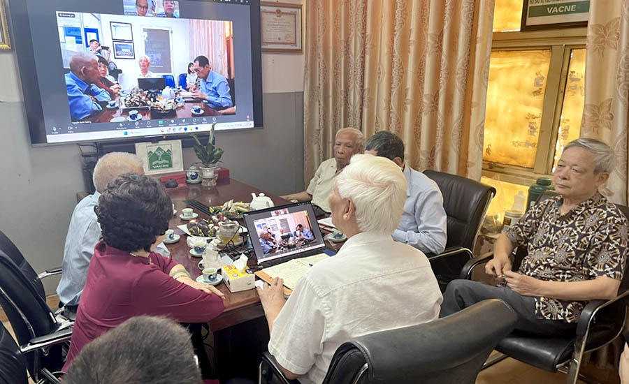 A group of people sitting around a tableAI-generated content may be incorrect.