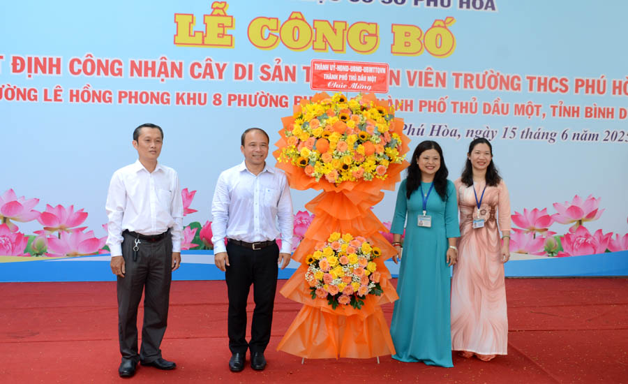 A group of people standing next to a large bouquet of flowersAI-generated content may be incorrect.