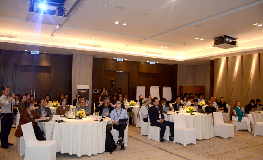A group of people sitting at tables in a roomAI-generated content may be incorrect.