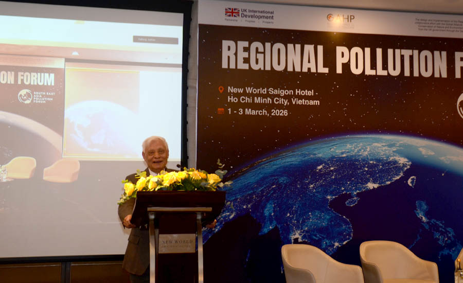 A person standing at a podium with flowersAI-generated content may be incorrect.